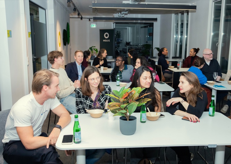 Participants in discussion around a table at a DigitsUp event